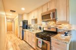 Recently remodeled kitchen with new appliances, gas range, and granite counters